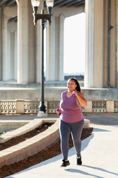 istock Pacific Islander woman running under city bridge 1370015717
