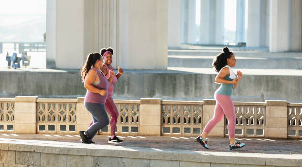 istock Three multiracial women running on city waterfront 1370015771