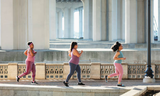 istock Three multiracial women running on city waterfront 1370015828