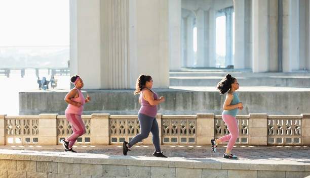 istock Three multiracial women running on city waterfront 1370015830