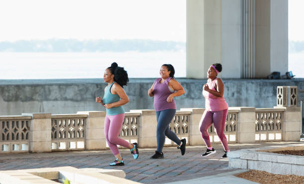 istock Three multiracial women running on city waterfront 1370015858