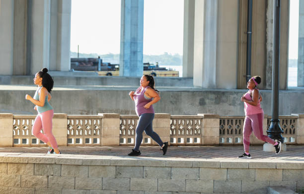 istock Three multiracial women running on city waterfront 1370015879