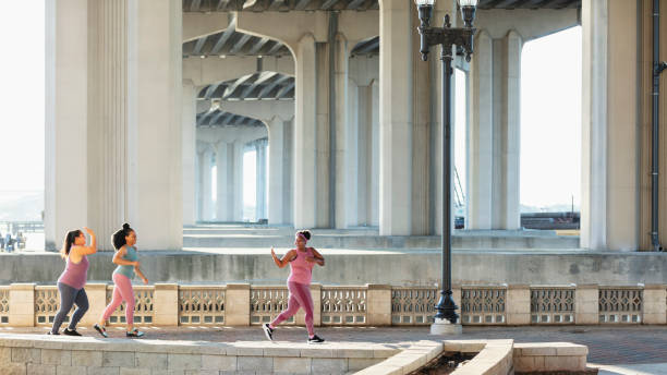 istock Three multiracial women running on city waterfront 1370016013