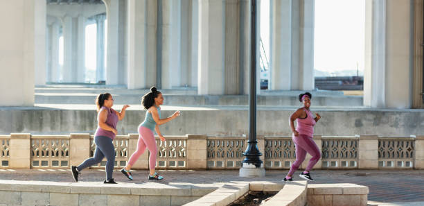 istock Three multiracial women running on city waterfront 1370016014