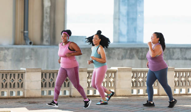 istock Three multiracial women running on city waterfront 1370016016