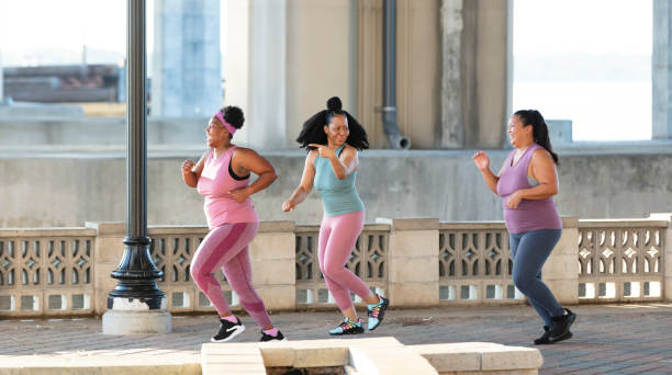 istock Three multiracial women running on city waterfront 1370016017