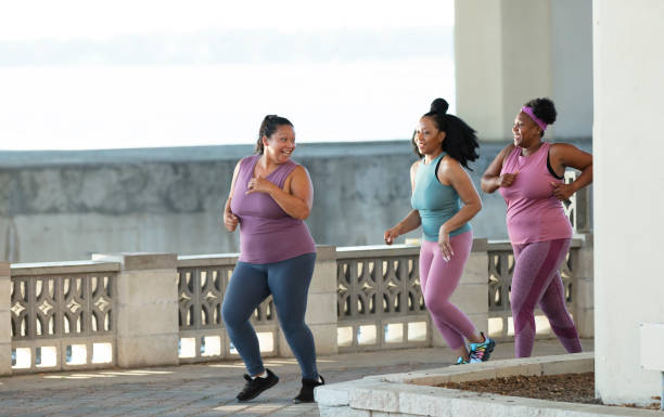istock Three multiracial women running on city waterfront 1370016094