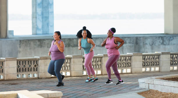 istock Three multiracial women running on city waterfront 1370016178
