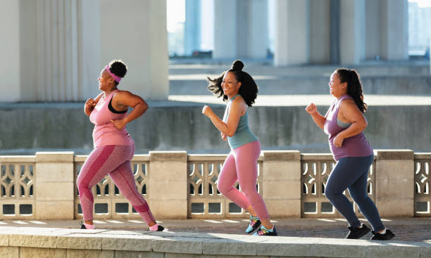 istock Three multiracial women running on city waterfront 1370016180