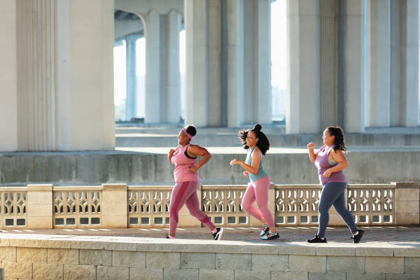 istock Three multiracial women running on city waterfront 1370016185