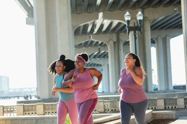 istock Three multiracial women running on city waterfront 1370016322