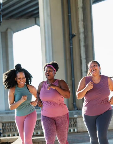 istock Three multiracial women running on city waterfront 1370016326