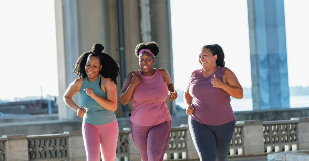 istock Three multiracial women running on city waterfront 1370016328
