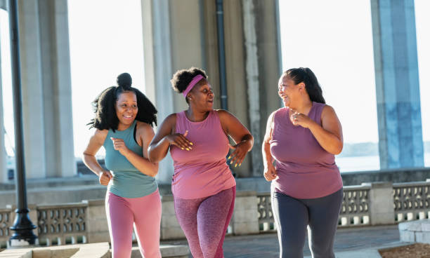 istock Three multiracial women running on city waterfront 1370016331