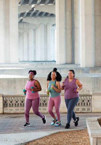 istock Three multiracial women running on city waterfront 1370016920