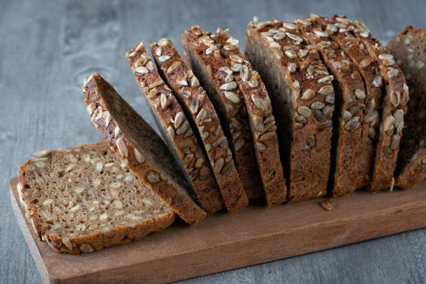 istock Sliced rye bread on cutting board. Whole grain rye bread with seeds 1370017289