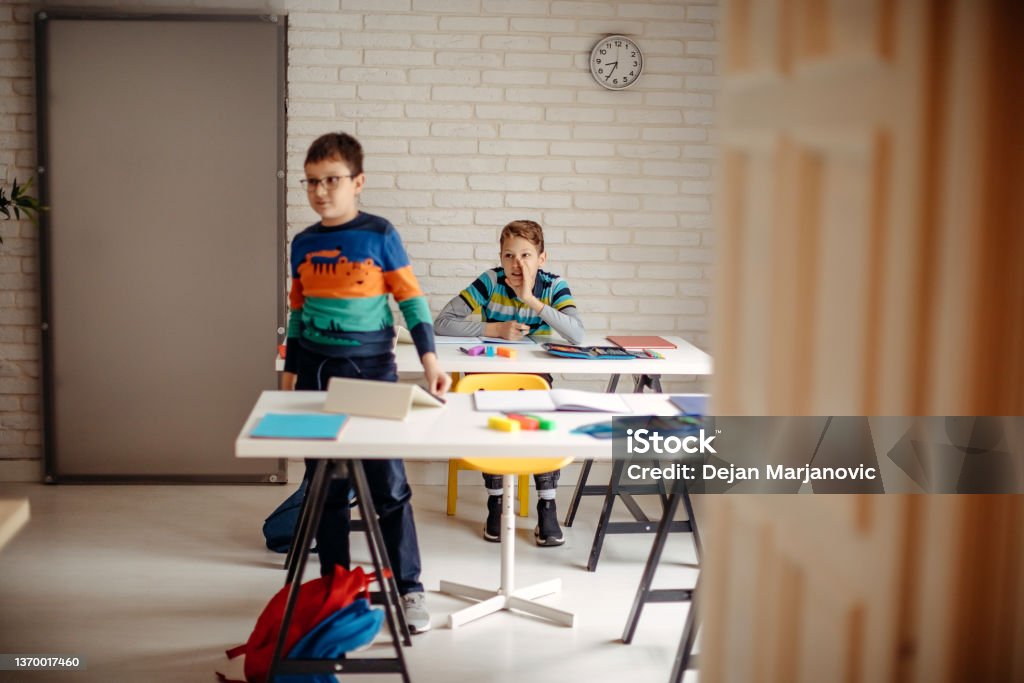 Private school for children Schoolchildren having class in private school answering questions 12-13 Years Stock Photo