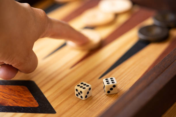 istock A Player Moves on an Olive Wood Backgammon Board 1370019873