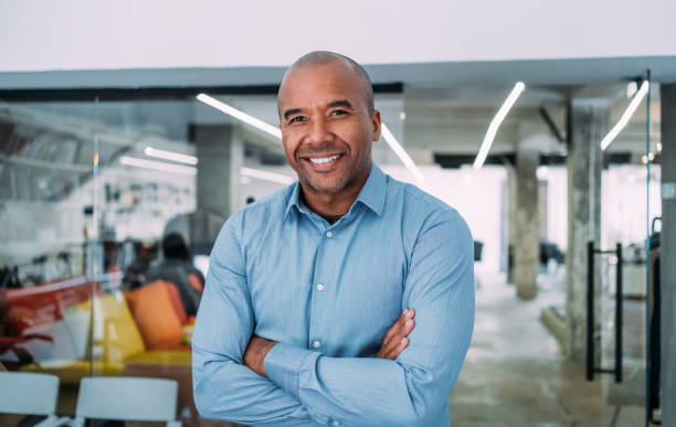Portrait of successful businessman. Portrait of handsome confident smiling businessman standing in the office and looking at camera. 40 44 years stock pictures, royalty-free photos & images