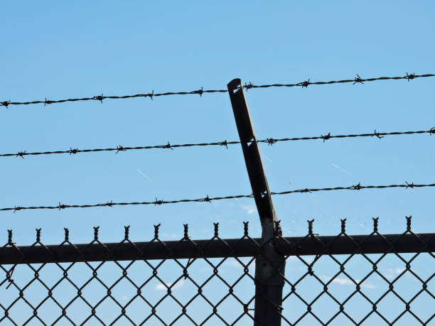 istock Chainlink Fence With Barbed Wire 1370024942