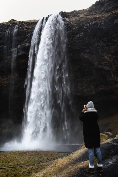 istock A woman take a photo on her smartphone 1370025659