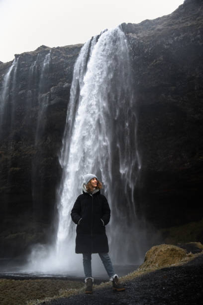 istock A woman standing in front of Seljalandsfoss 1370025767