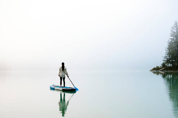Tranquil sports and relaxation outdoors. Paddleboarding and and water sports.