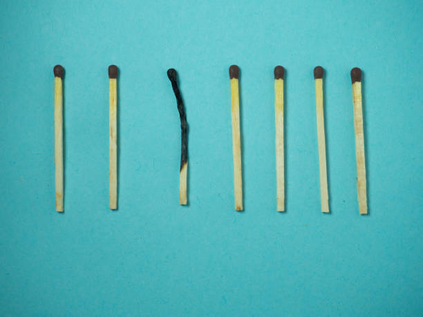 istock Matches on a blue background.  One against all. Burnt match. 1370036692