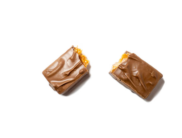 istock Broken chocolate bar on a white background. Slices of chocolate. 1370036710