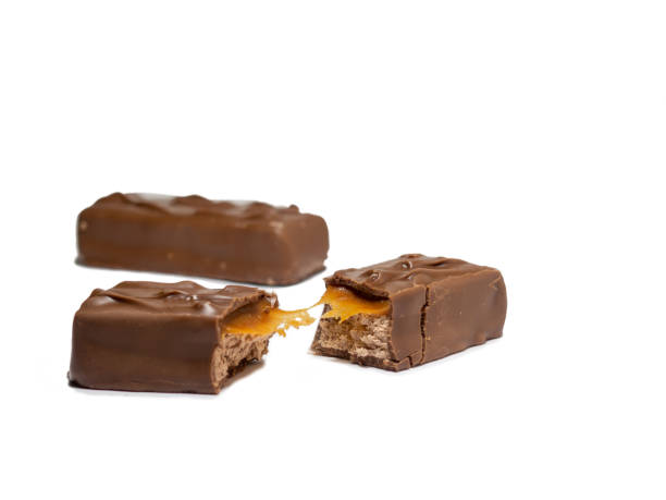 istock Broken chocolate bar on a white background. Slices of chocolate. 1370036714