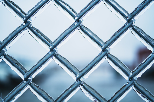 Close up of an ice covered chain link fence.