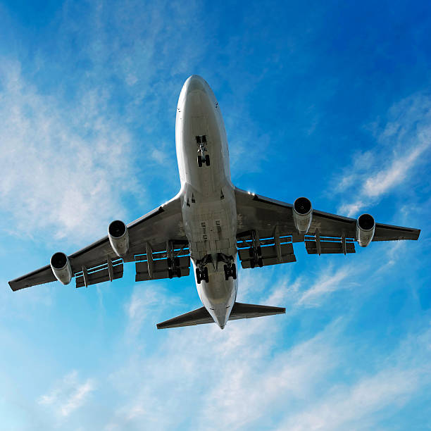 istock jumbo jet airplane landing in bright sky 137004083