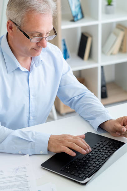istock working employee home office man typing laptop 1370046340