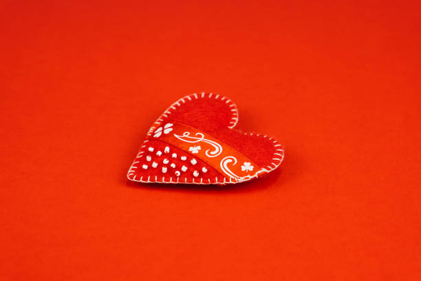 Top view valentine background. Red textile heart on red papper. Valentine's Day concept with copy space.