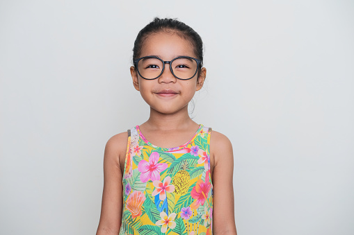 Asian kid wearing glasses smiling confident when looking to the camera