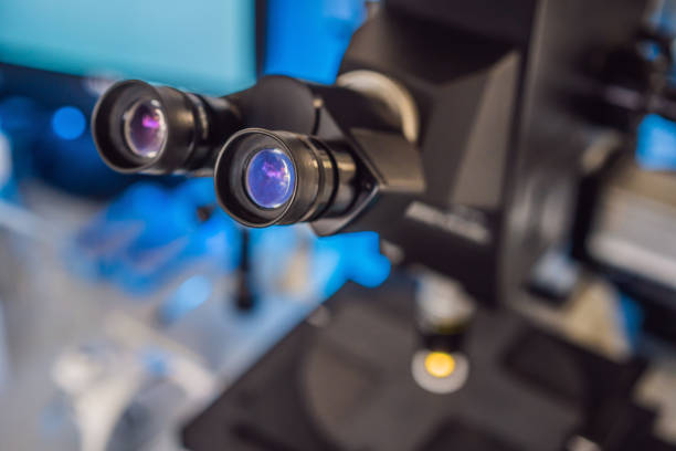 istock Laboratory Microscope. Scientific and healthcare research background coronavirus 1370054230