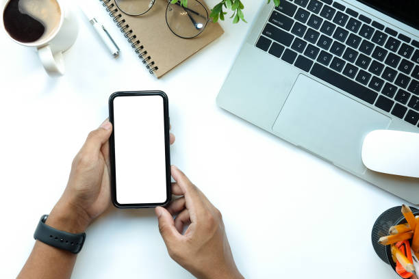 istock Businessman using smart phone while sitting at his office desk. 1370061237