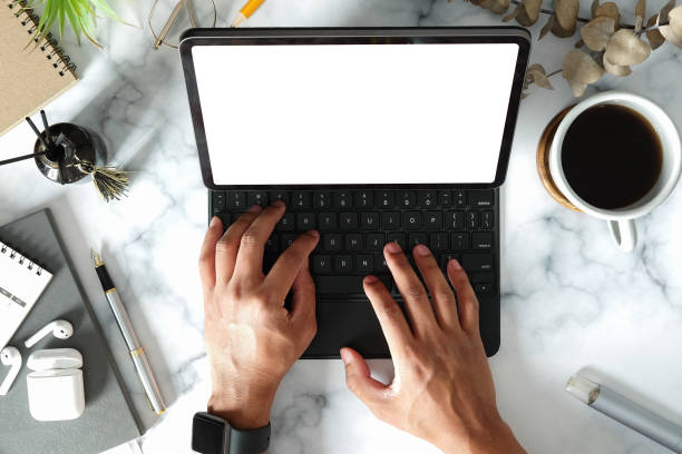 istock Above view young man hands typing on wireless keyboard of digital tablet. 1370061277