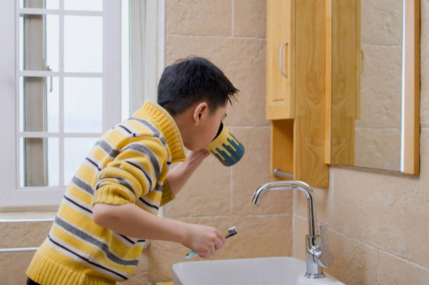 istock Asian boy brushing teeth in bathroom 1370062509