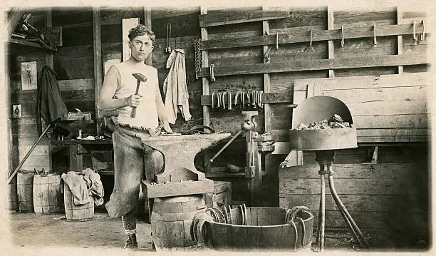 A 1914 photograph of a young blacksmith working in his shop - Fort Riley, Kansas, 12th Calvary. NOTE TO INSPECTOR: photo passed down in our family.