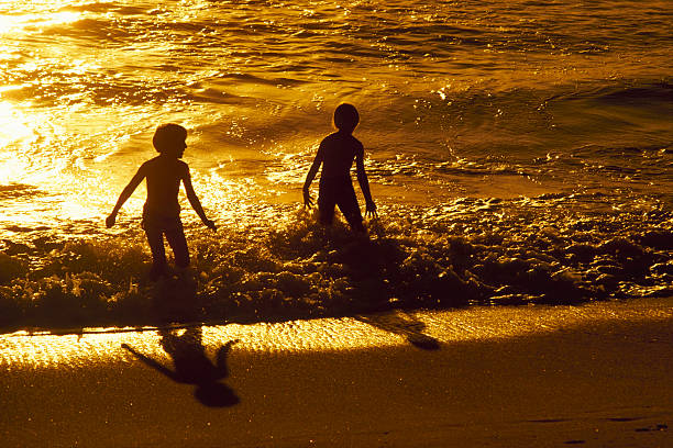 Children Playing In The Ocean stock photo
