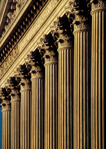 A close-up of columns on the exterior of a courthouse stock photo