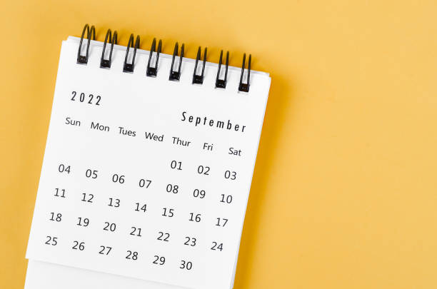 istock September 2022 desk calendar on light yellow background. 1370071726