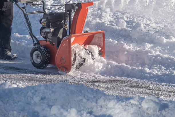 istock cordless electric snow blower clearing pavement in winter 1370072056