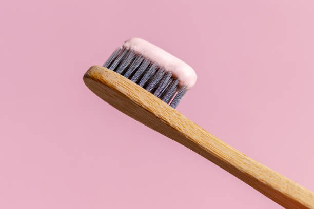 istock Ecological toothbrush made from natural bamboo. Sustainable lifestyle concept, zero waste. Copy space. Pink background 1370074963