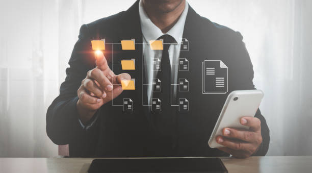istock An IT specialist in the workplace is installing a Document Management System (DMS) on a laptop computer. File archiving software for businesses 1370076625