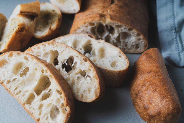 istock Freshly baked homemade bread with crispy crust on gray background 1370078554