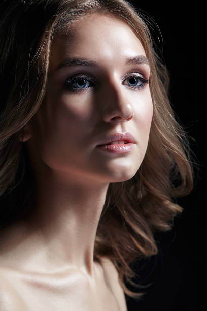 istock Female with wavy hair on black background. 1370081239