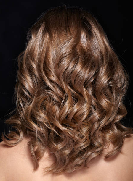 istock Woman from backside with curly hair 1370081848