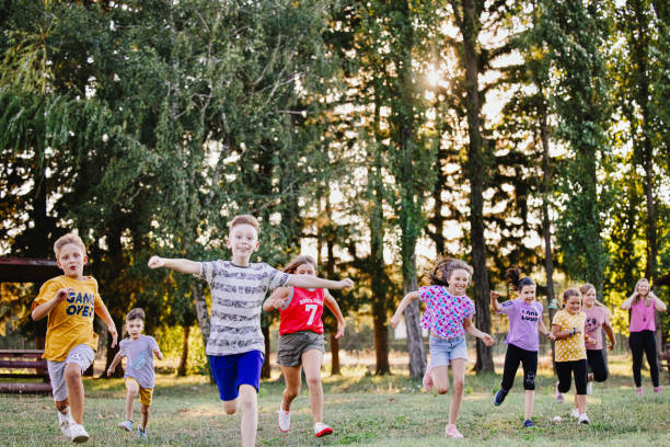 istock Group Of Young Children Running Towards Camera In Summer Camp 1370082980